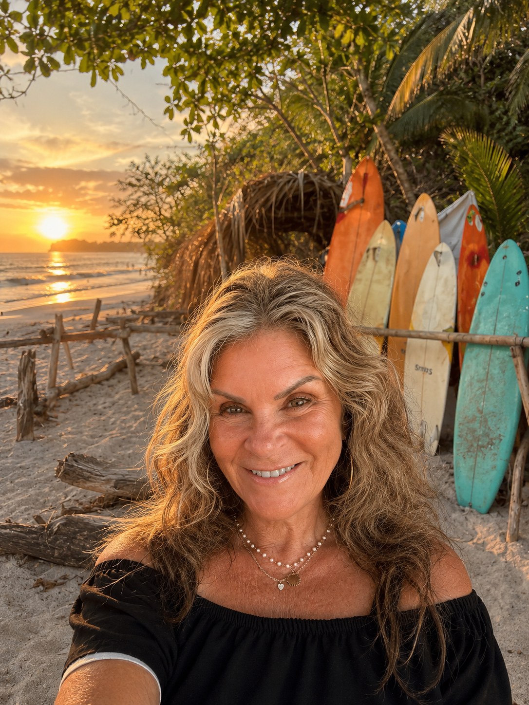 Lori Burke smiling on the beach at sunset