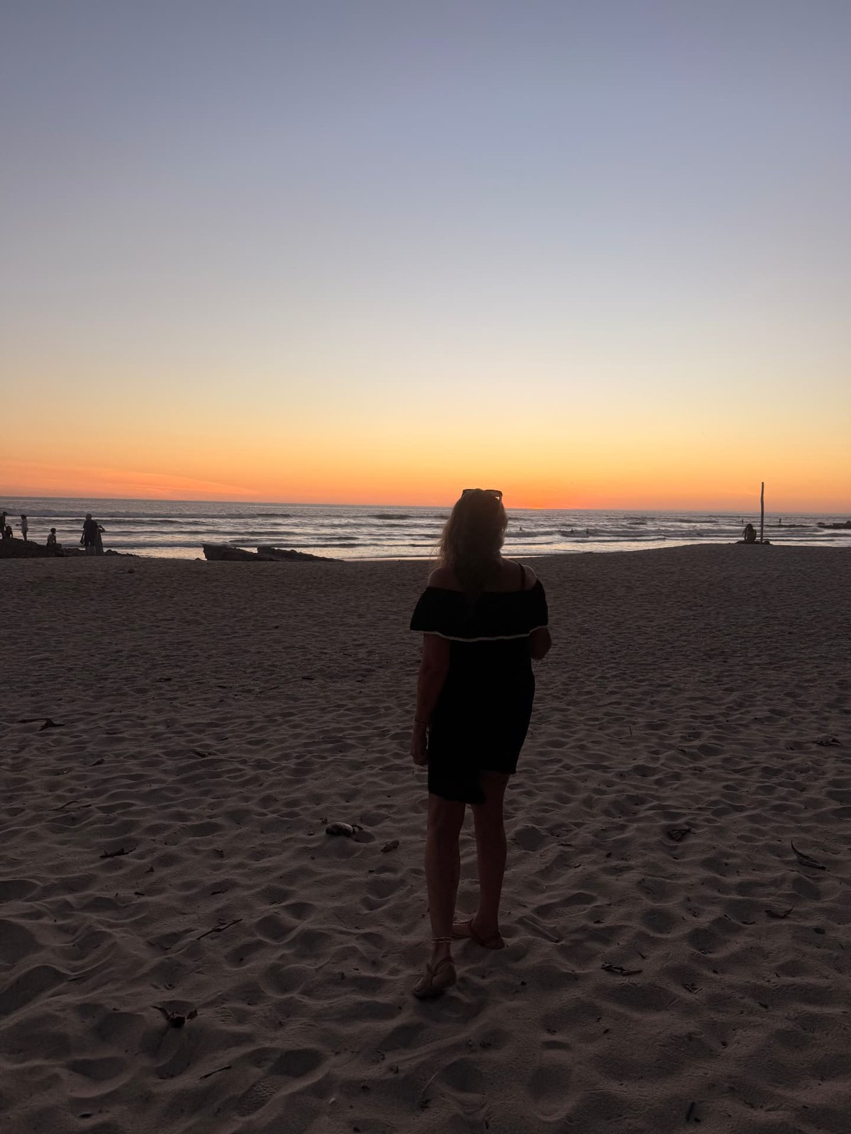 Lori looking out at the sunset from the beach